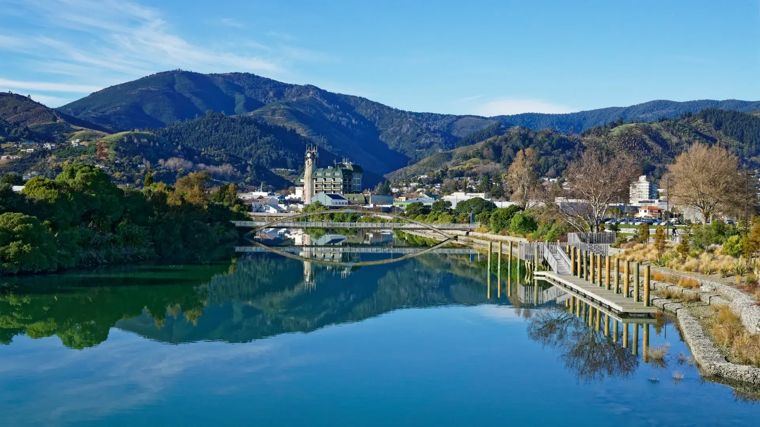 A calm river reflecting the hills around Nelson